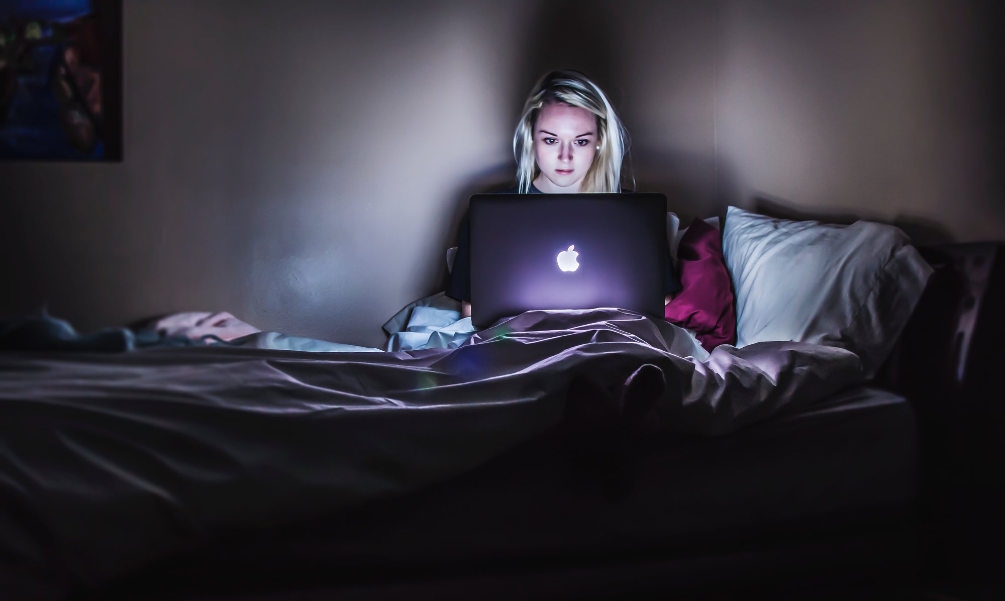 Woman watching computer at night blue light